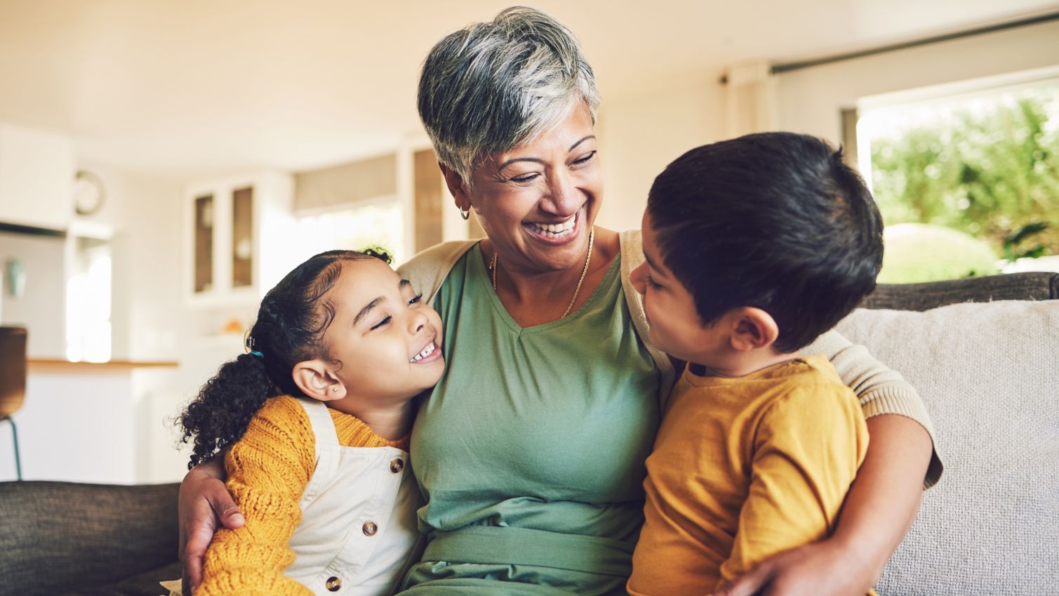 adult hugging two children