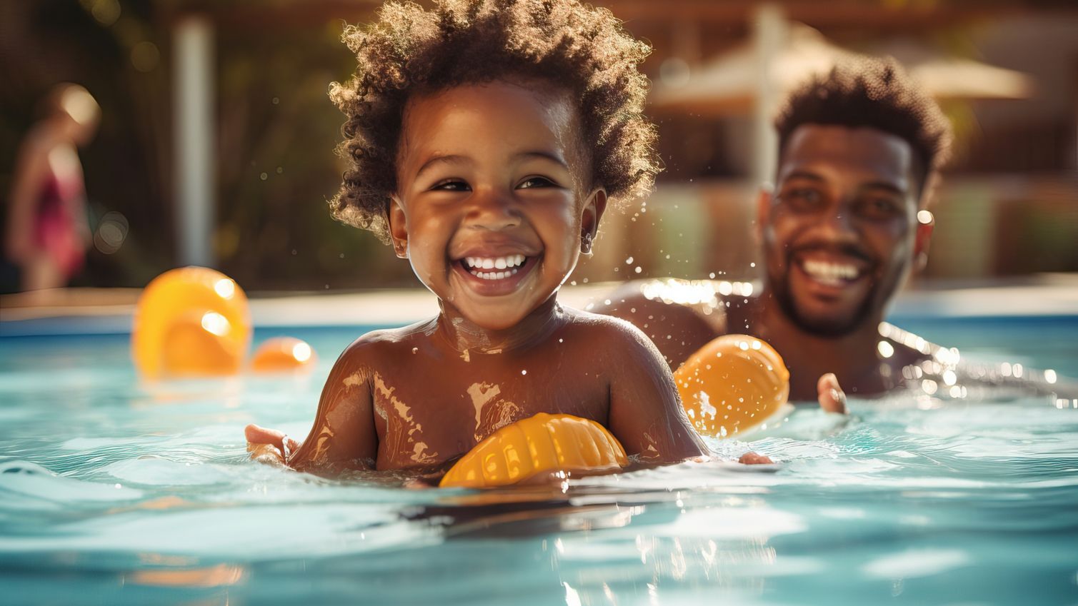 Father and child playing in pool.