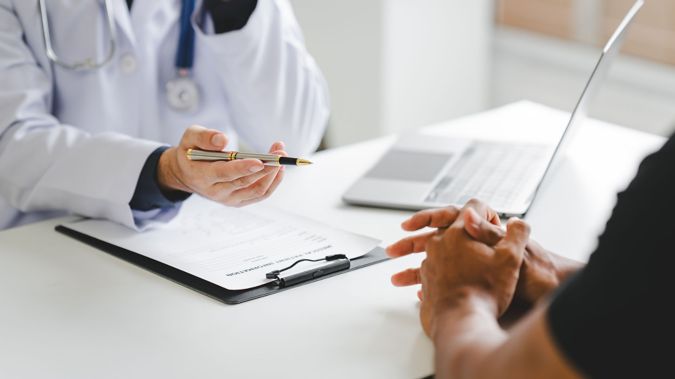 A provider speaks with a patient. 