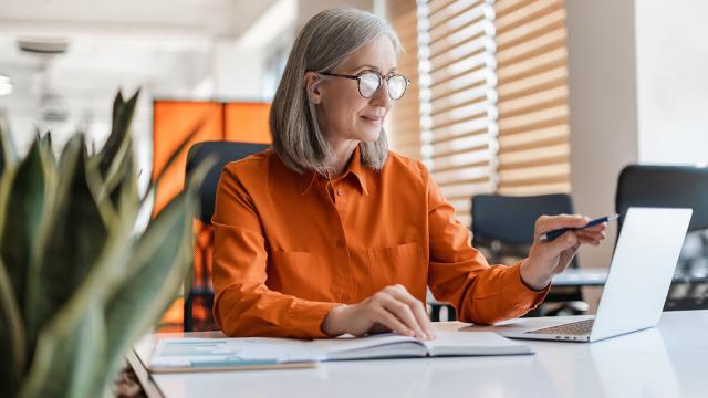 A woman uses a computer in her office.