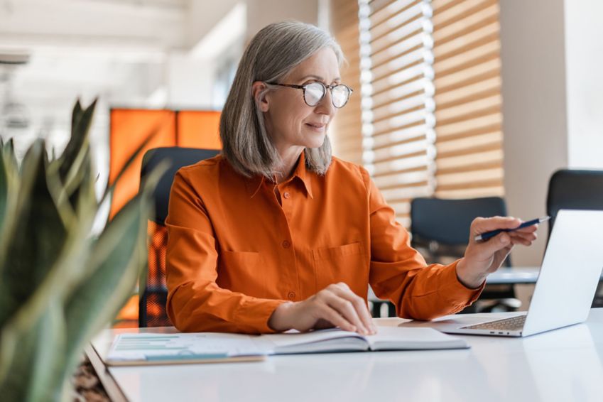 A woman uses a computer in her office.