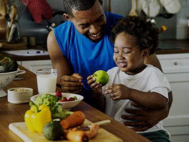 Father and child eating healthy meal