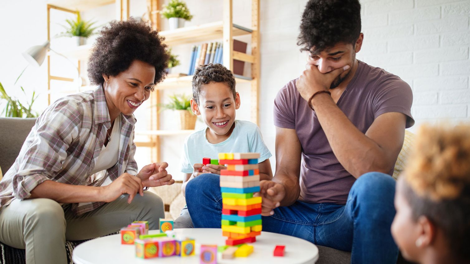 Family with young children plays a board game.