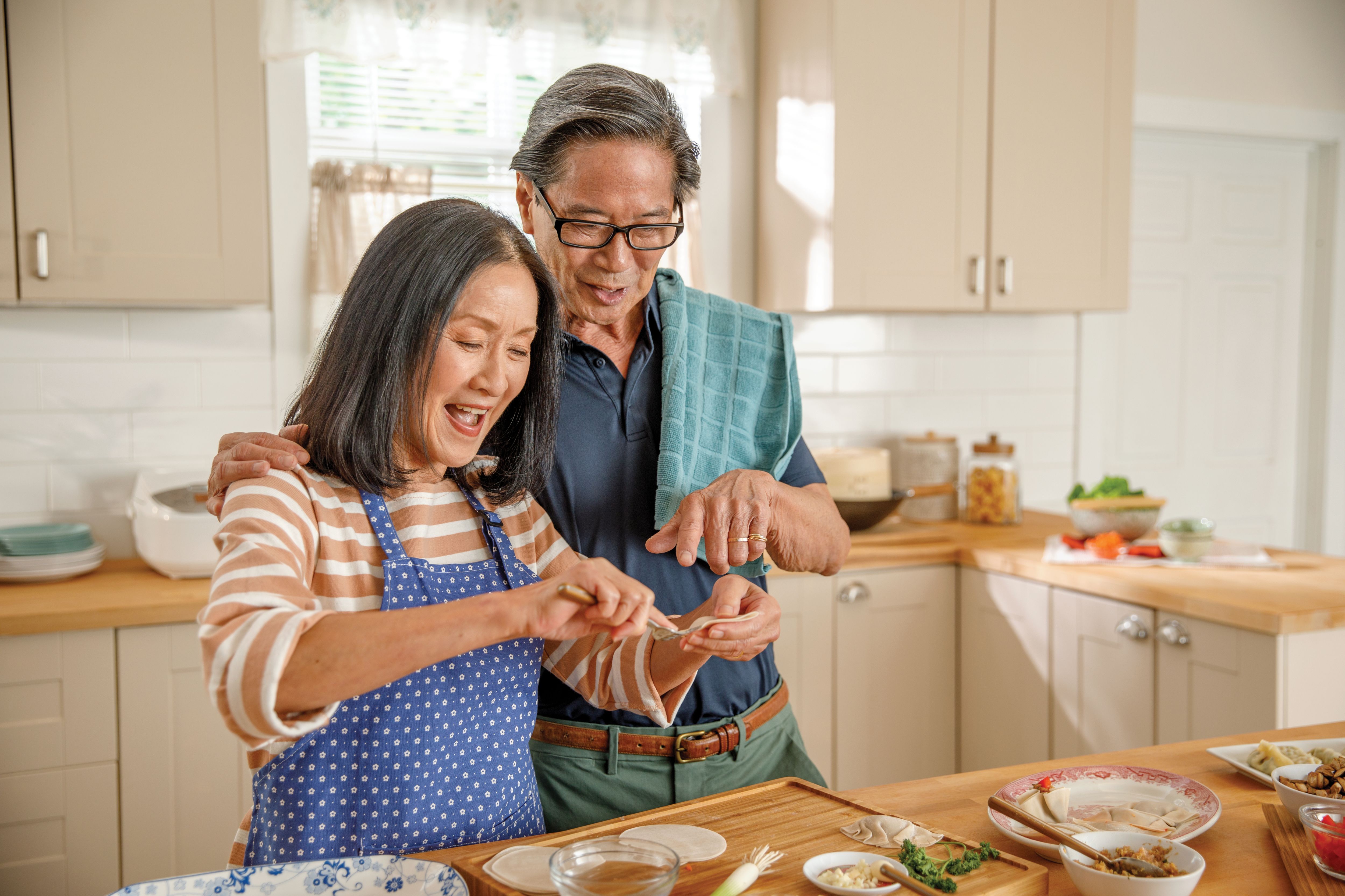 Senior couple prepares a meal together in the kitchen