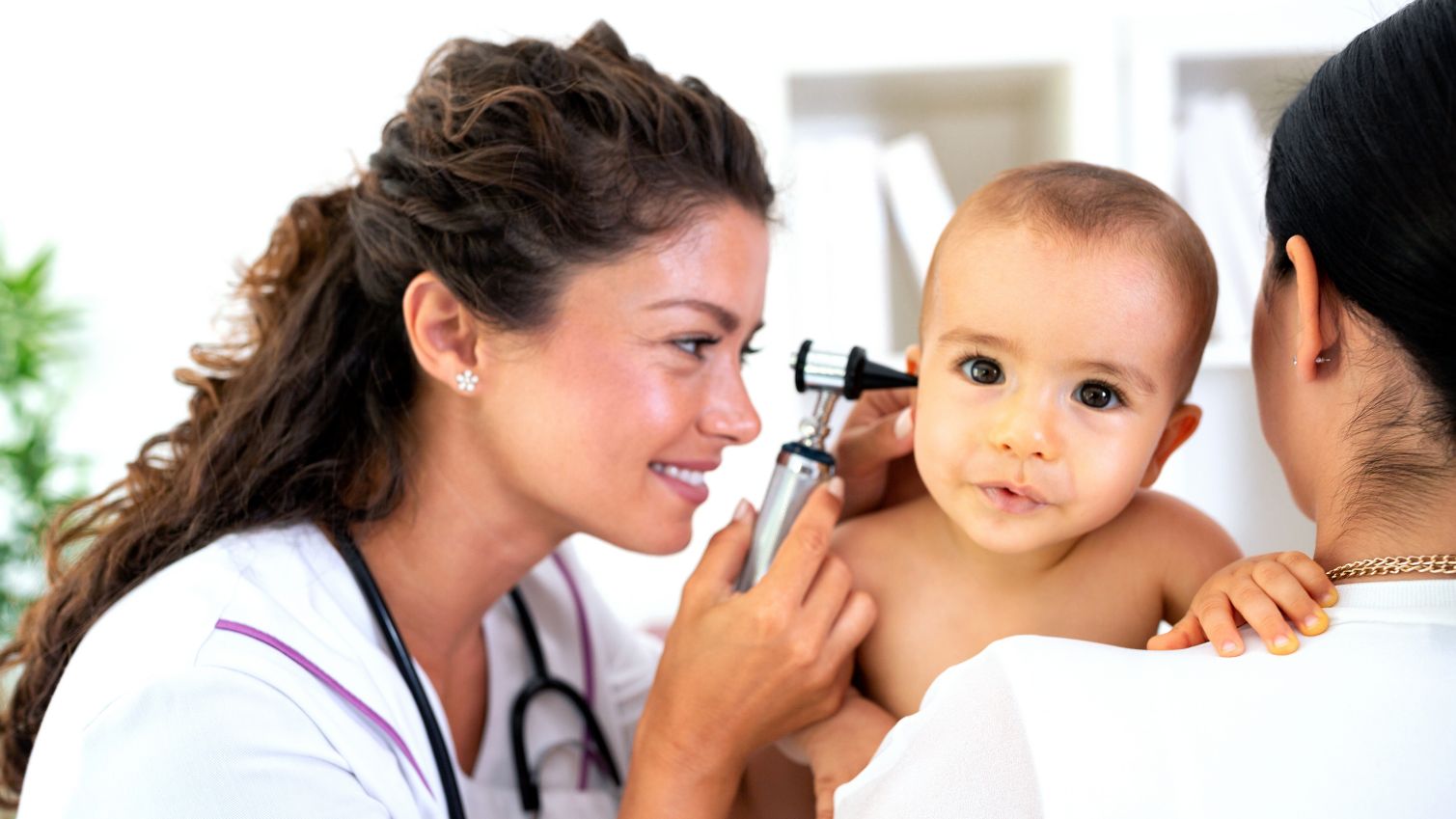 Medicaid doctor examines baby's ear