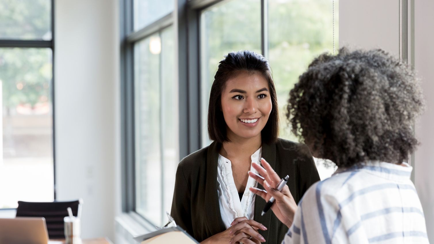 manager speaking with female adult member in office