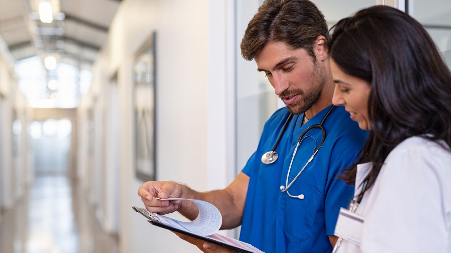 Two young physicians look over a patient's chart