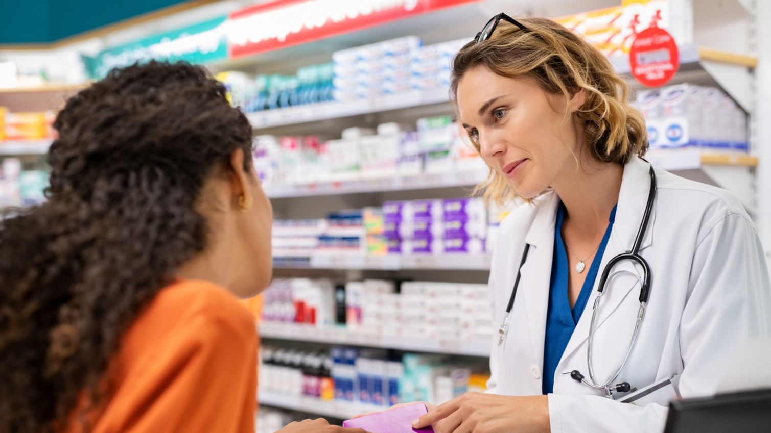 Pharmacist discusses medication with patient