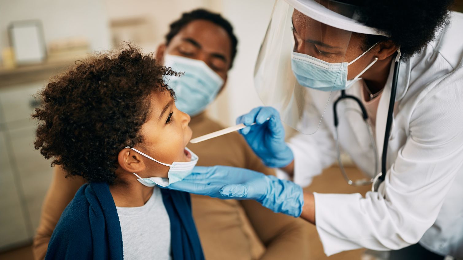 A female doctor performs a checkup on a young child