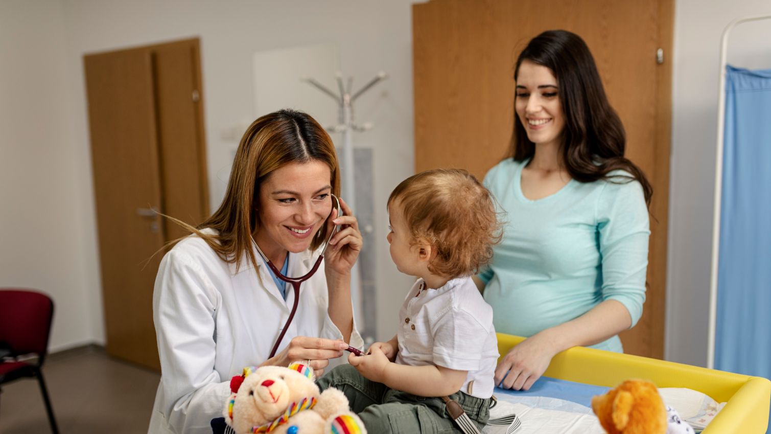 A pediatrician examines a young boy