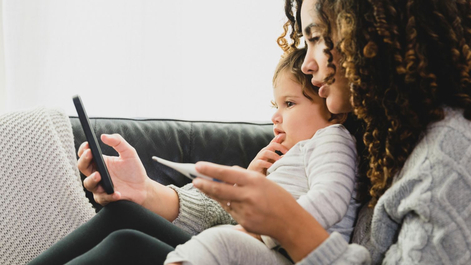 Adult and child looking at smartphone