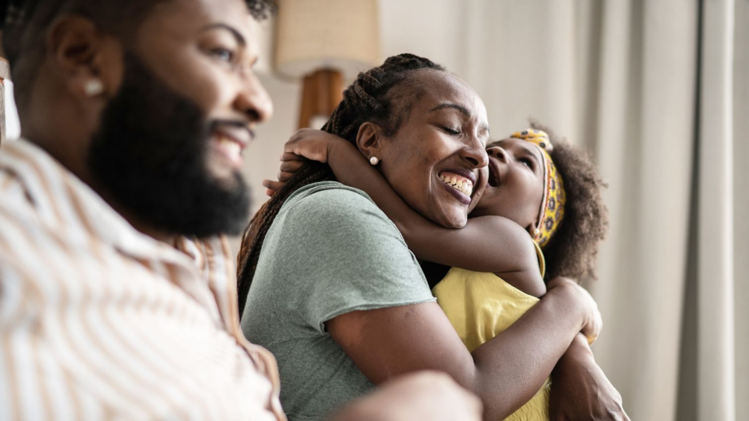 Mom and dad play with their daughter