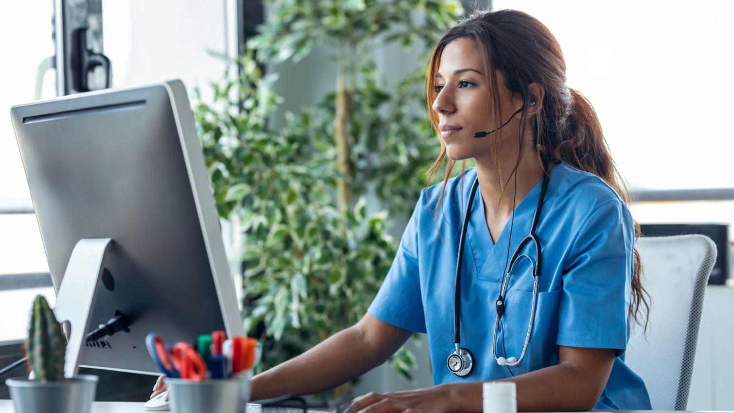 Young female doctor working on her computer