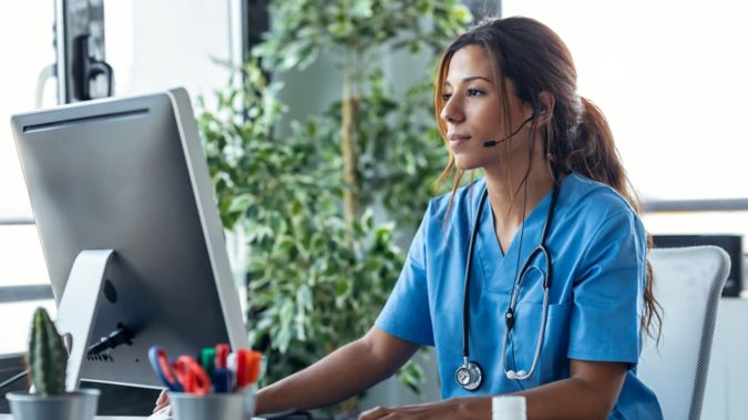 Young female doctor working on her computer