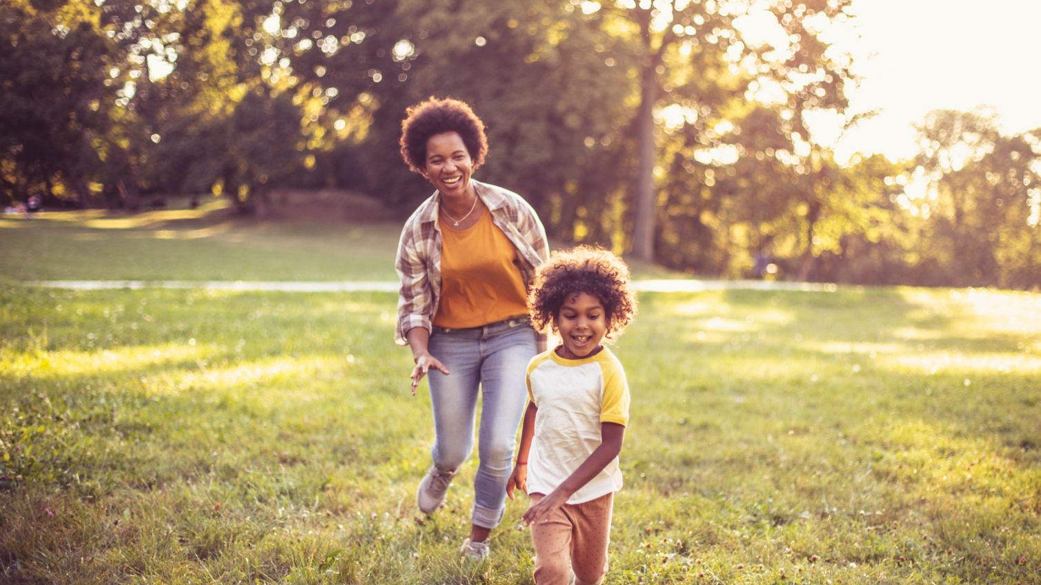 Mom plays with daughter outside