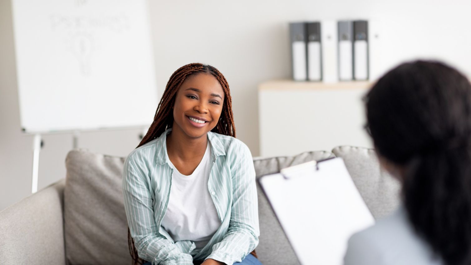 Patient sitting on couch speaking to doctor