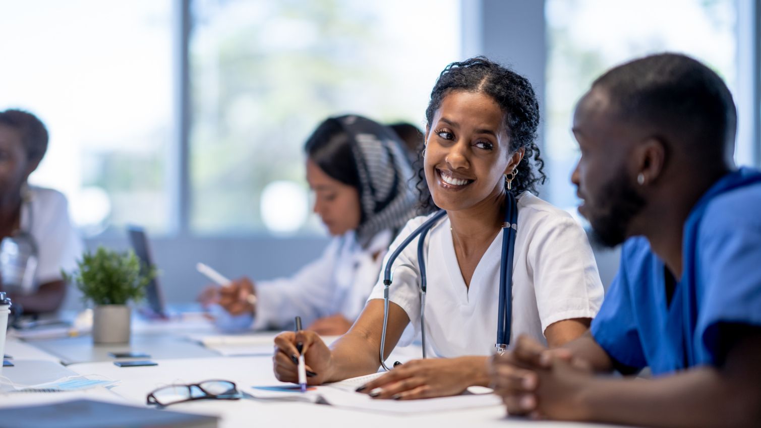 Female doctor talking with male nurse