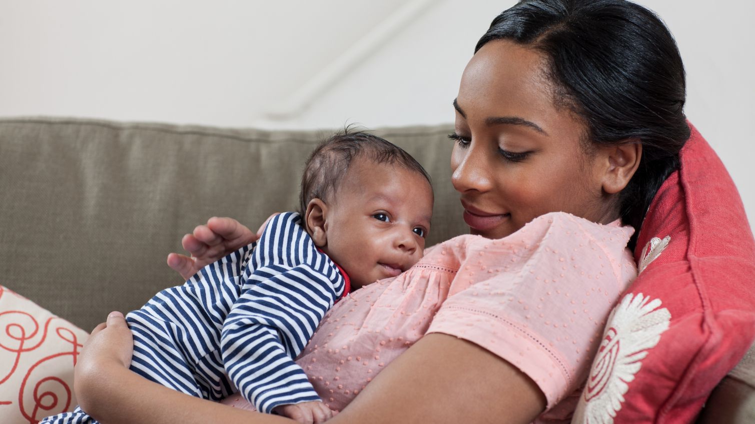 Medicaid member holds newborn