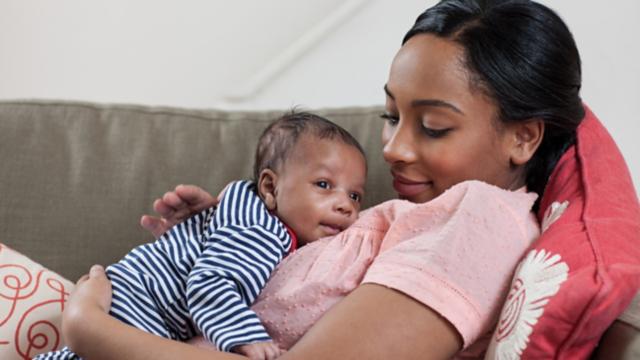 Medicaid member holds newborn