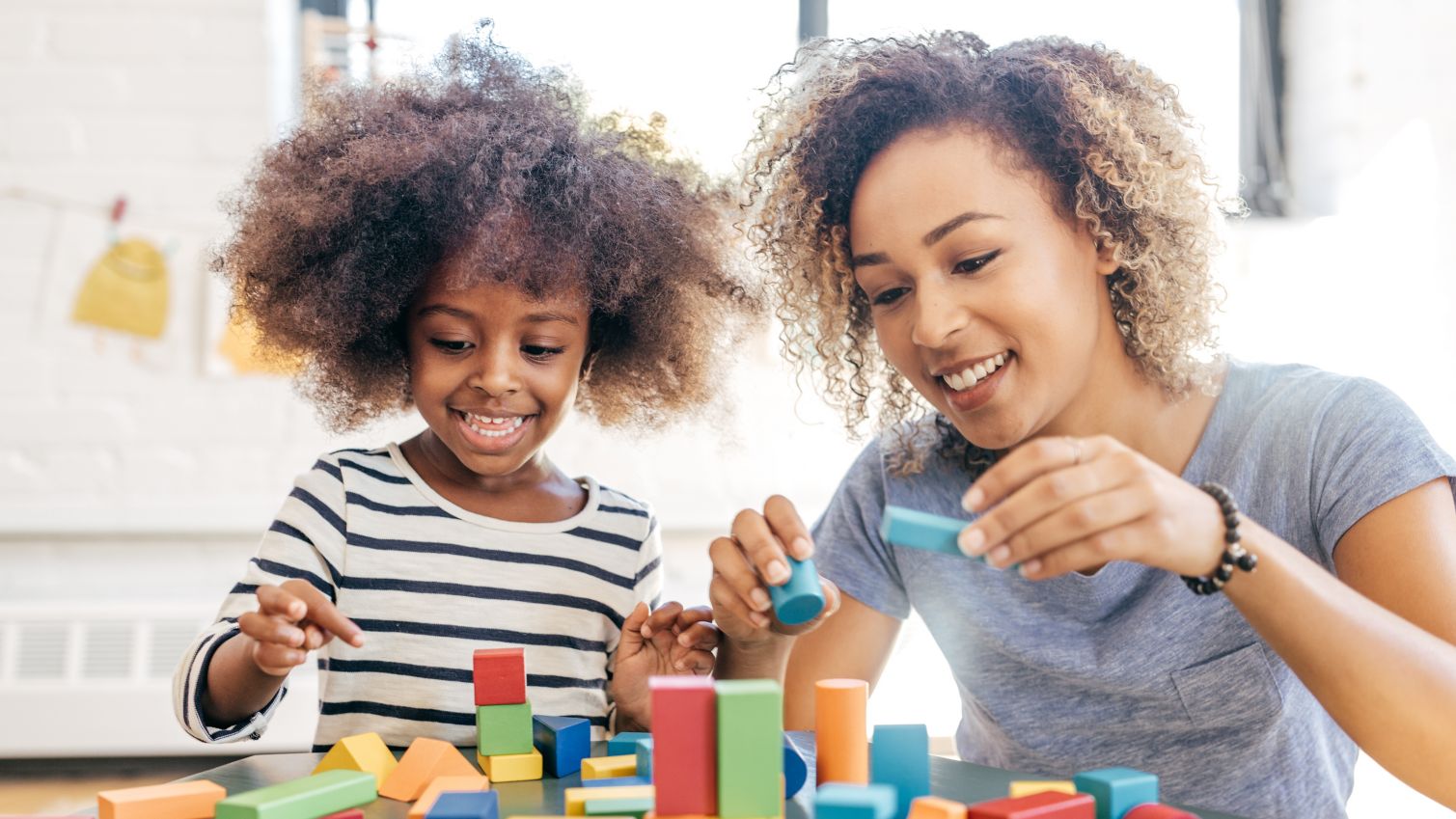 Mom plays with blocks with daughter