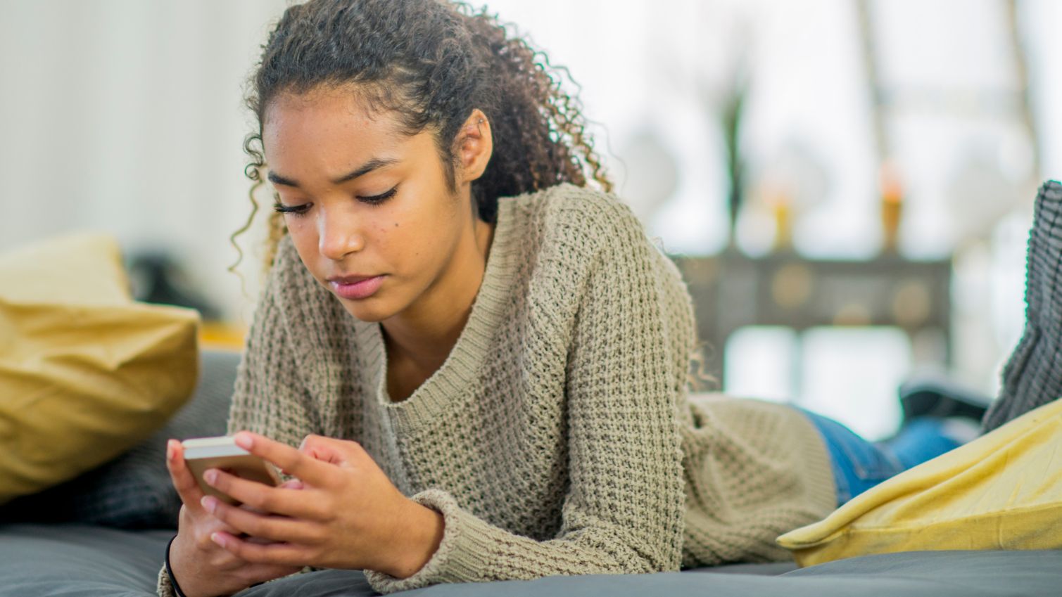 Medicaid member reviews information on her phone