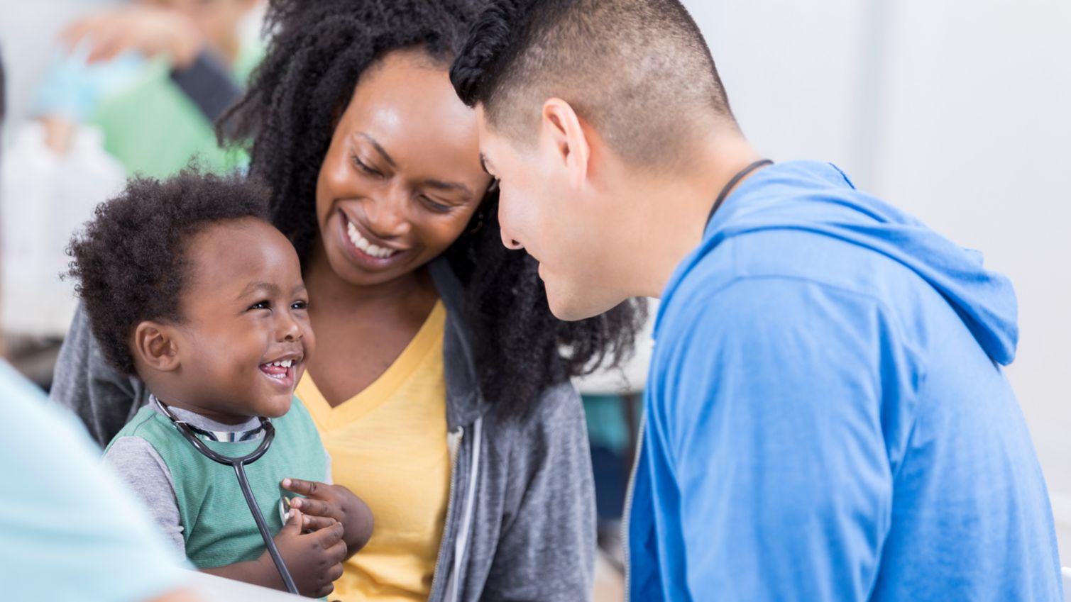 Medicaid doctor examines baby while mom watches