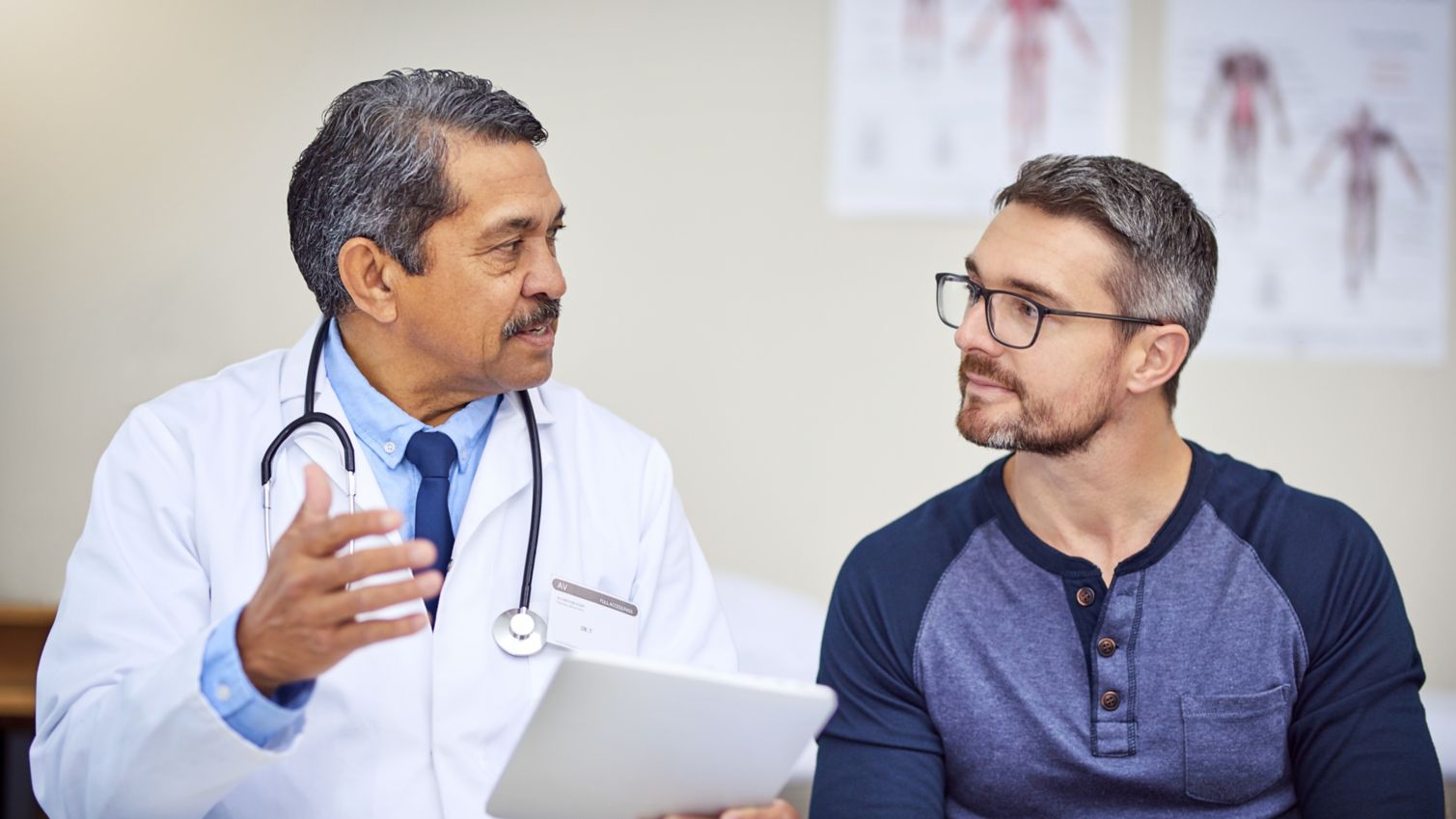 male patient going over paperwork with doctor