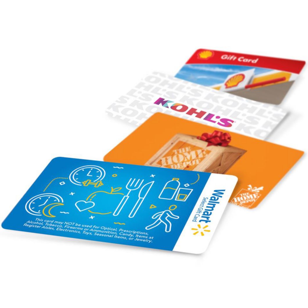 A series of gift cards for Walmart Select, The Home Depot, Kohl’s and Shell are laid out on a table.