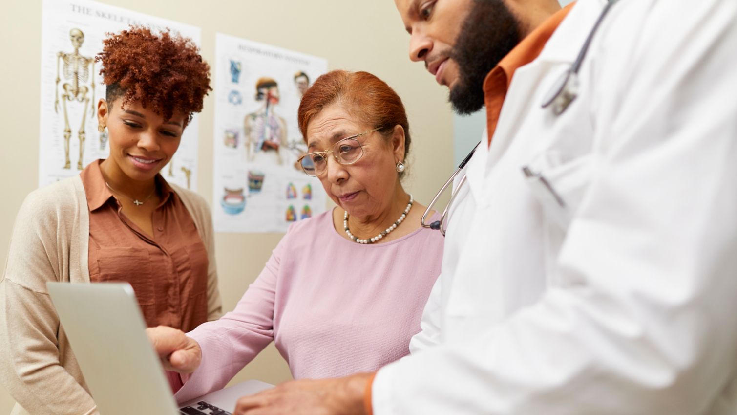 Health care providers looking at a computer screen
