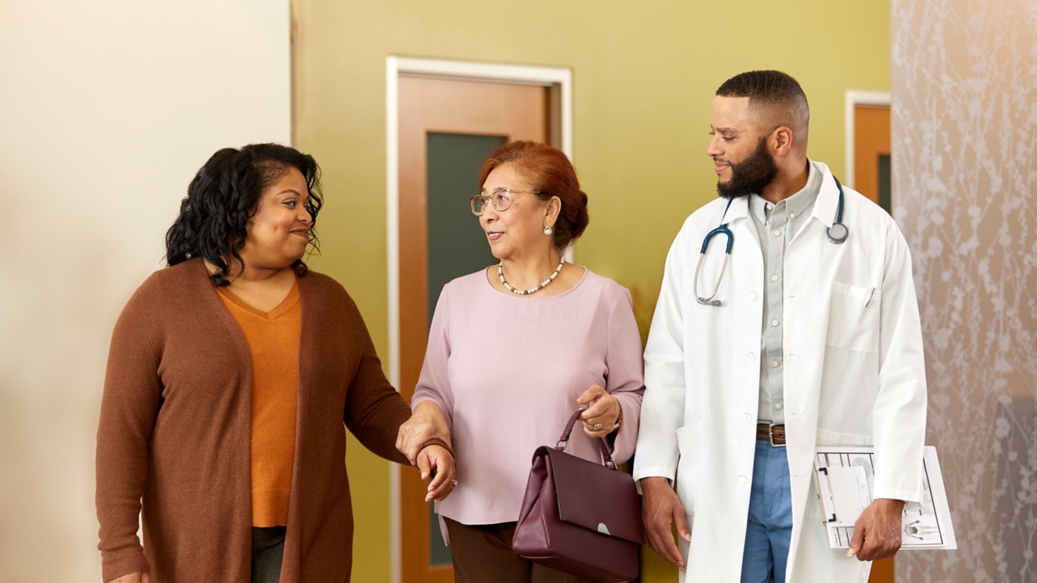 A physician talks with a patient and her family