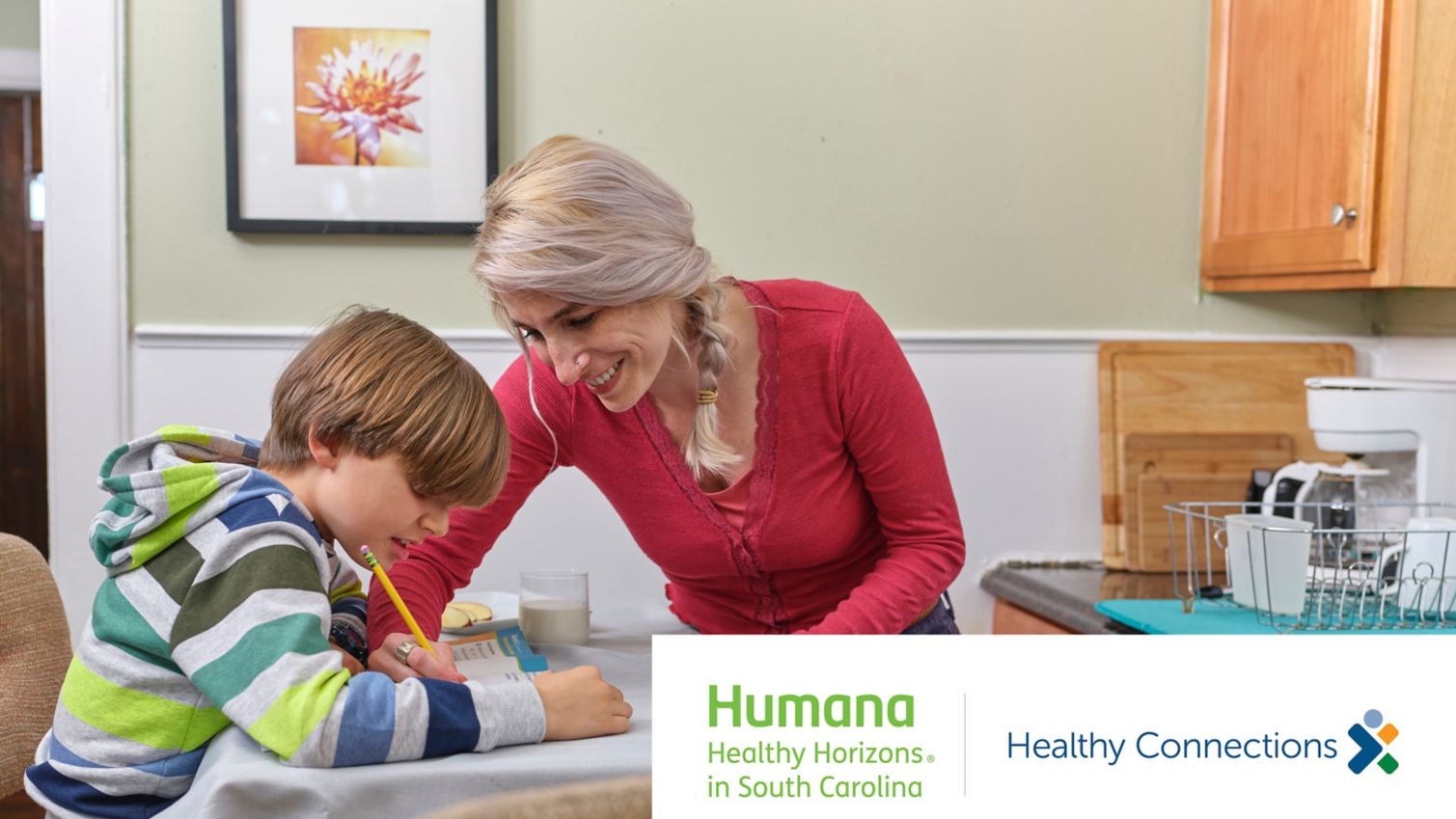 Caregiver and young Medicaid member doing school work