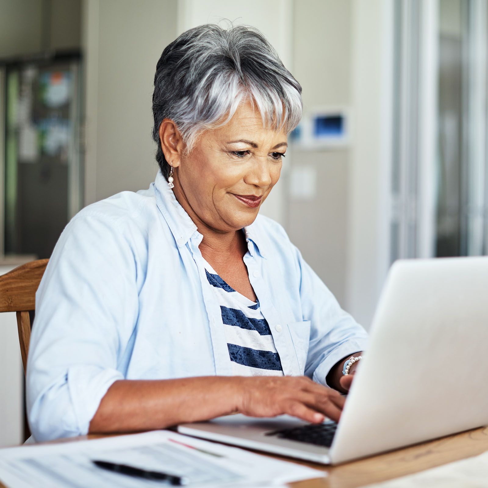 Senior woman using laptop.