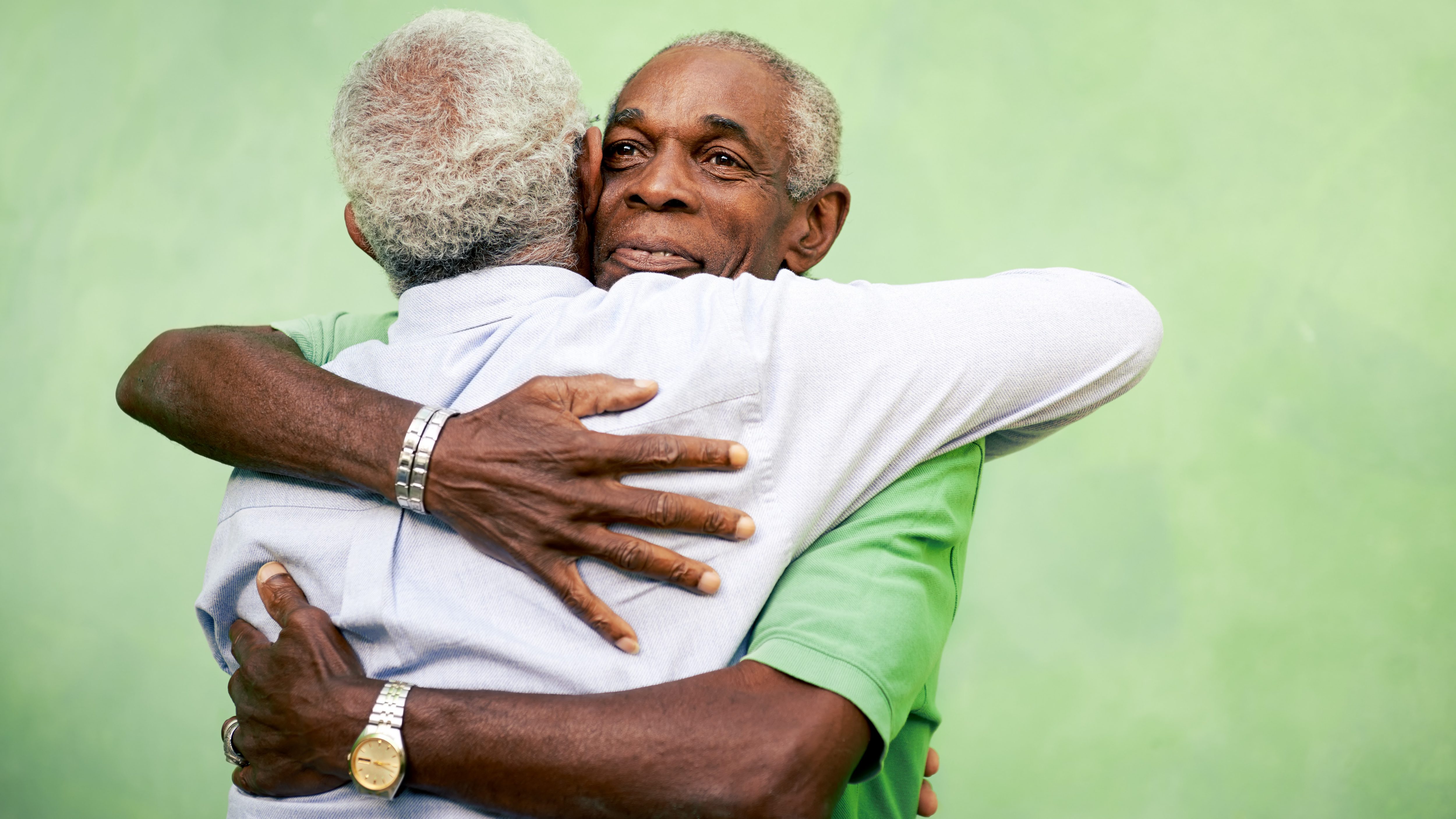 Active retired old men and leisure, two senior black brothers hugging outdoors