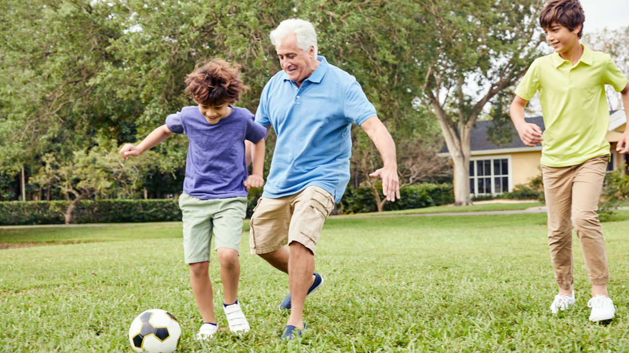 Three people playing soccer