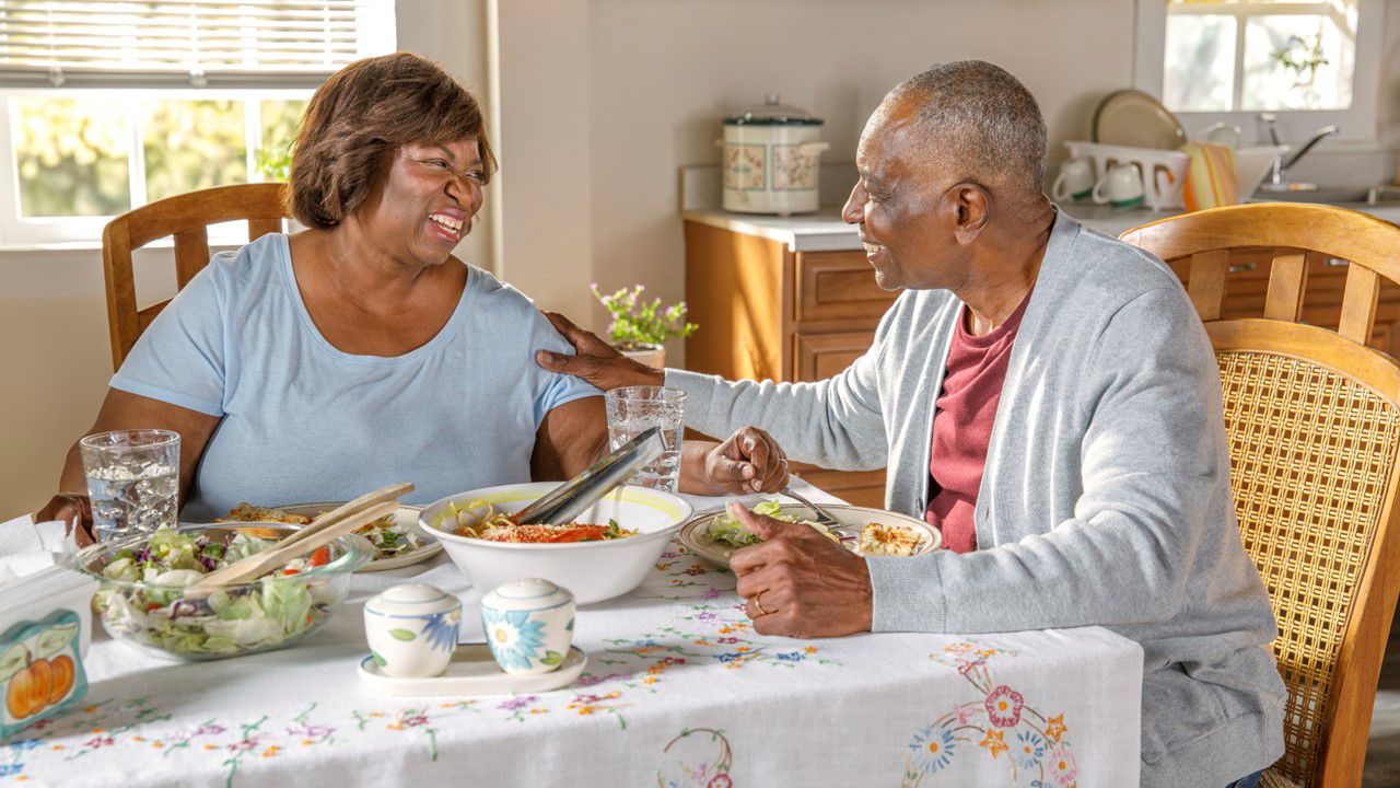 Older African American couple eating a meal
