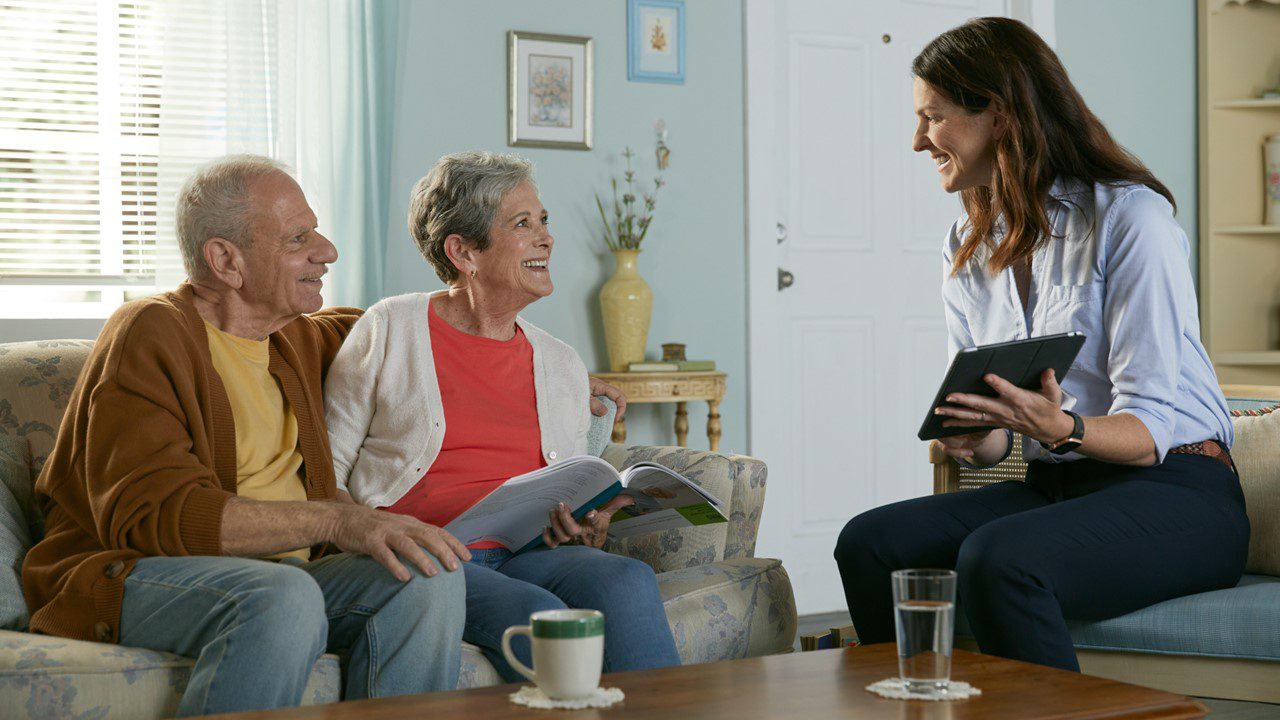 MarketPoint insurance sales agent working with older couple to choose supplemental benefits