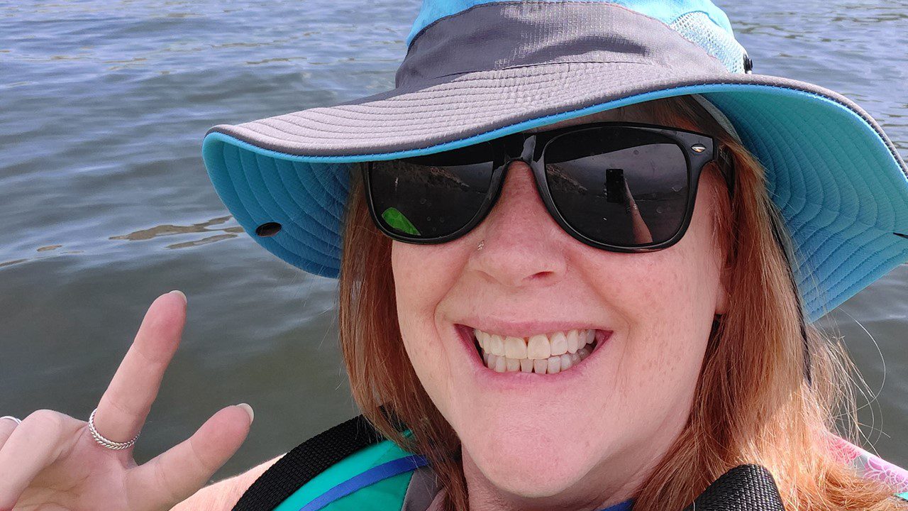 Woman kayaking and smiling