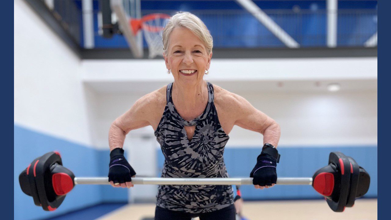 Woman lifting weights in gym