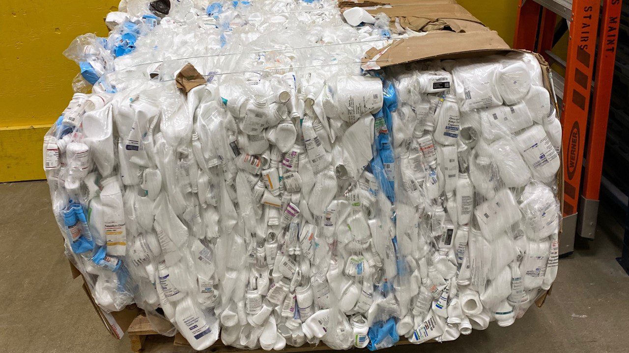 Prescription bottles crushed and bundled for recycling.