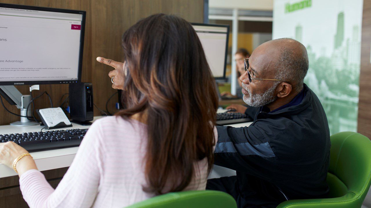 Man and woman looking a health information on computer screen