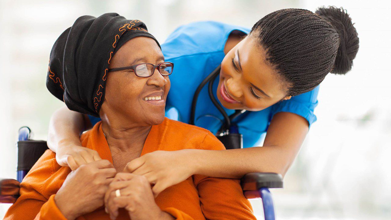 Woman in wheelchair and nurse