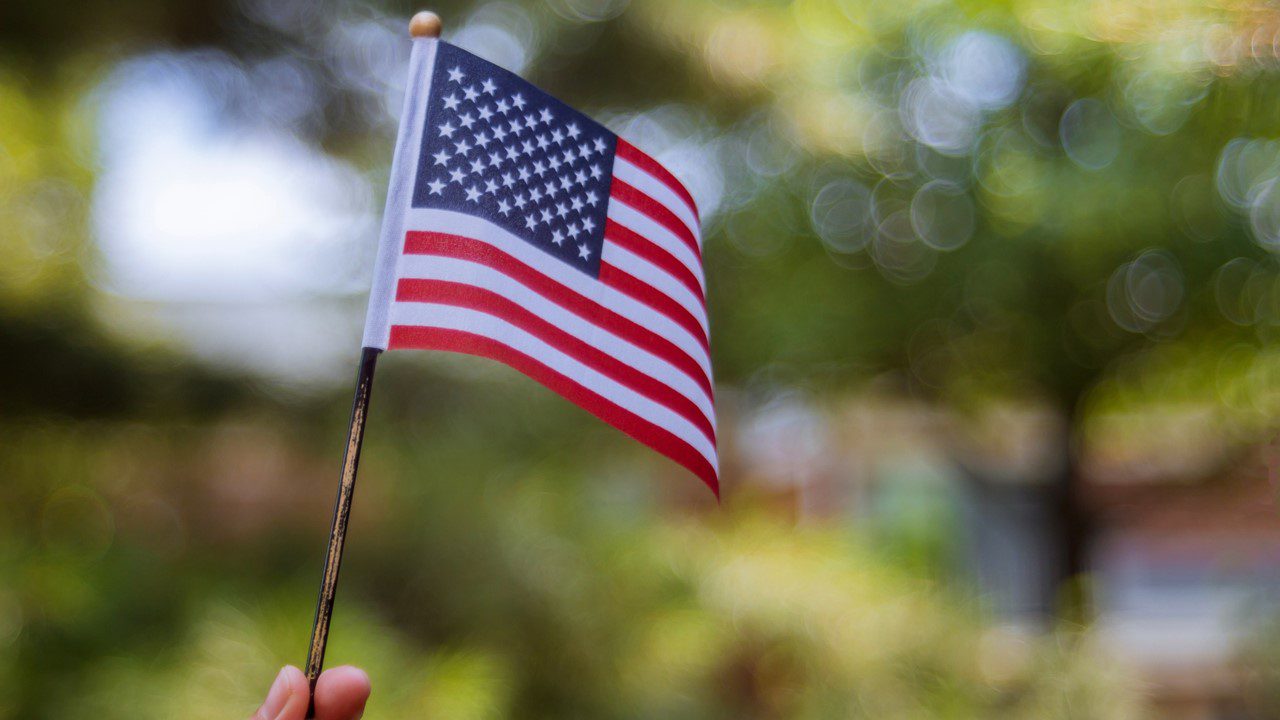 Hand holding American flag