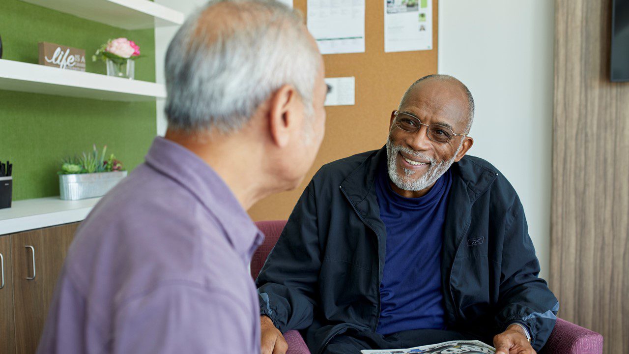 Two older men talking