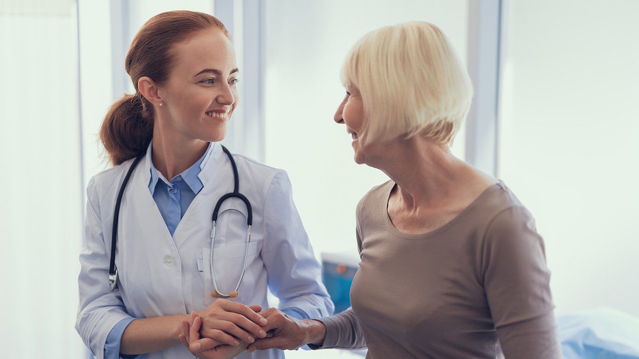 Doctor holding patient's hand