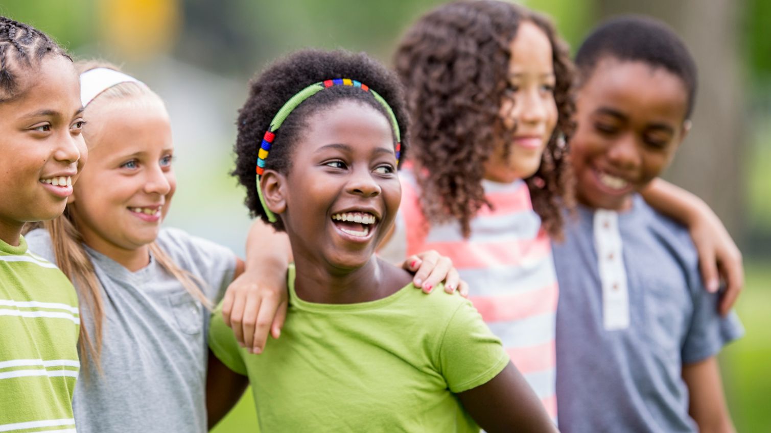 A group of kids gathers together outside