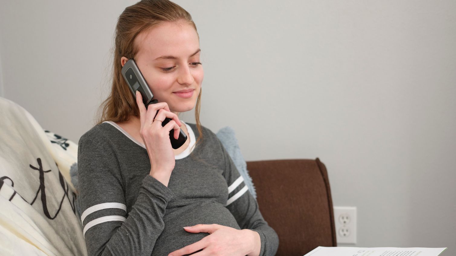 Young pregnant Medicaid member on the telephone