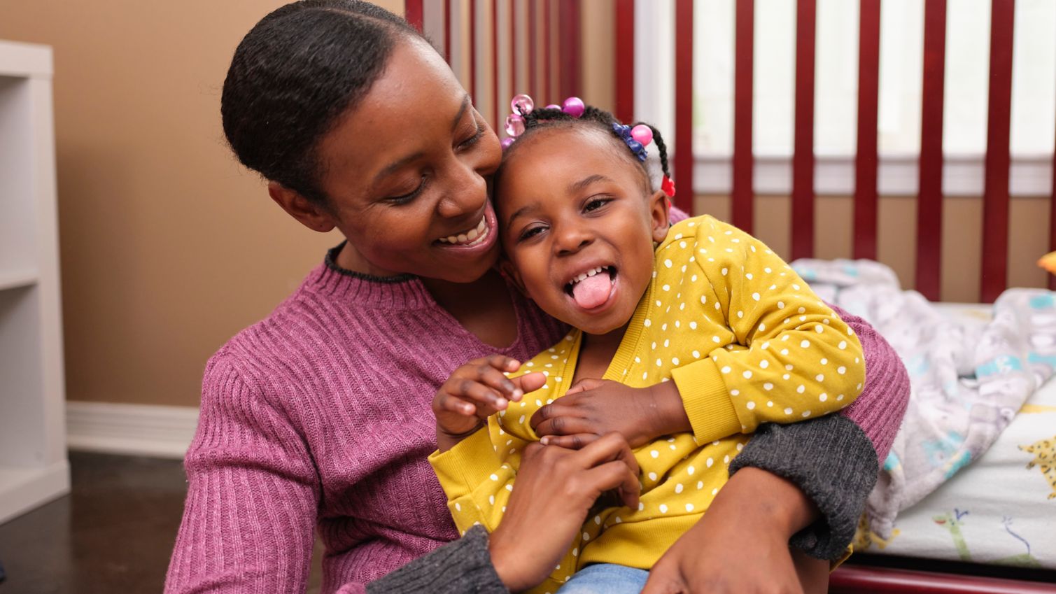 Young Medicaid member laughing with mom