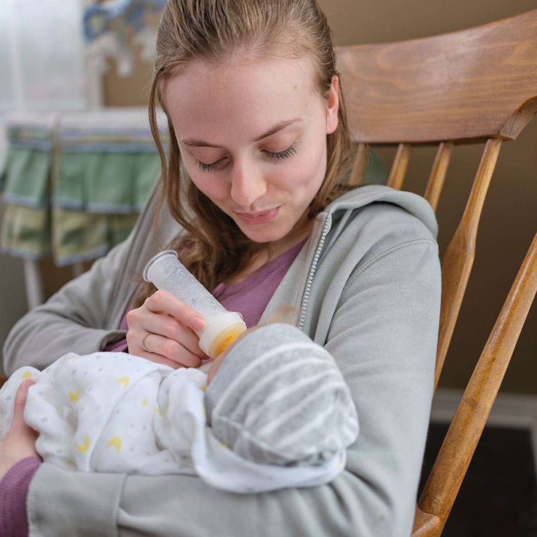 Medicaid member and new mom feeds her baby by bottle