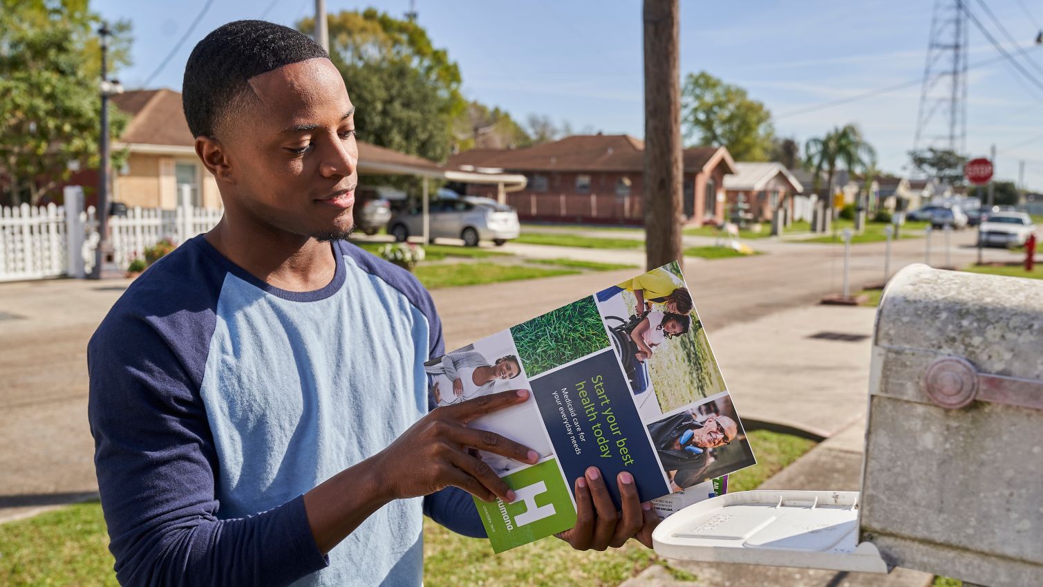 Medicaid member takes his Enrollee Handbook from the mailbox