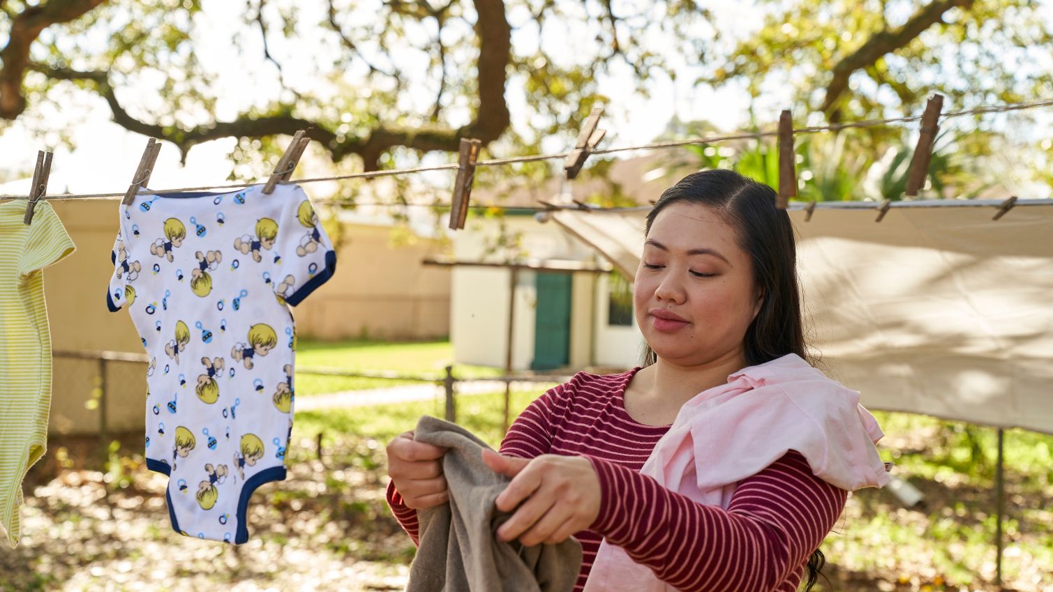 Woman hangs laundry outside